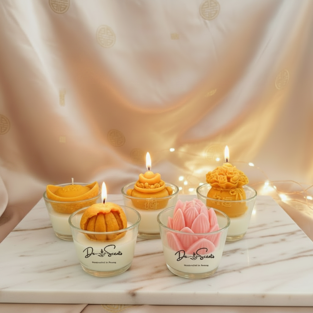 Decorative candles in glass holders on a marble surface with a soft, warm background.